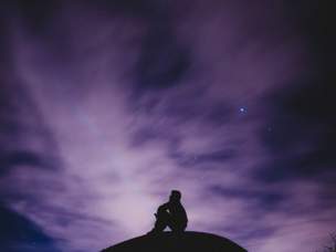 Picture of a person looking up at stars