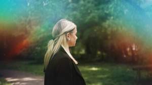 Woman daydreaming in park Woman daydreaming in park