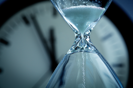 decision making under pressure hour glass in front of clock
