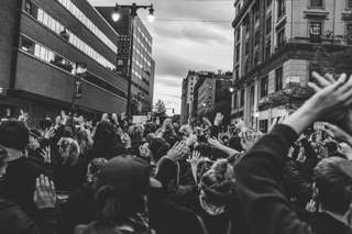 crowd of people with their hands up