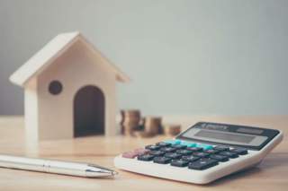 calculator, model home, coins and pen