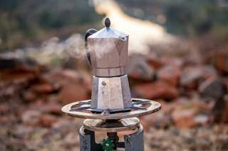 kettle boiling on an outdoor stove