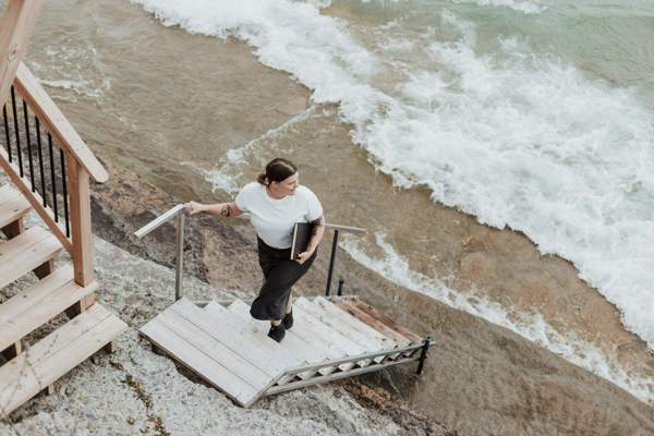 the ethics of expectation woman climbing a set of stairs