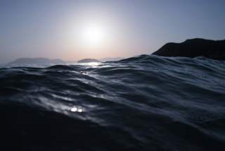 Sinking into the ocean with a glimpse of the horizon
